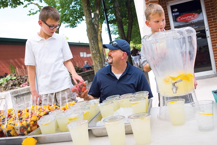 Dad and sons selling lemonade