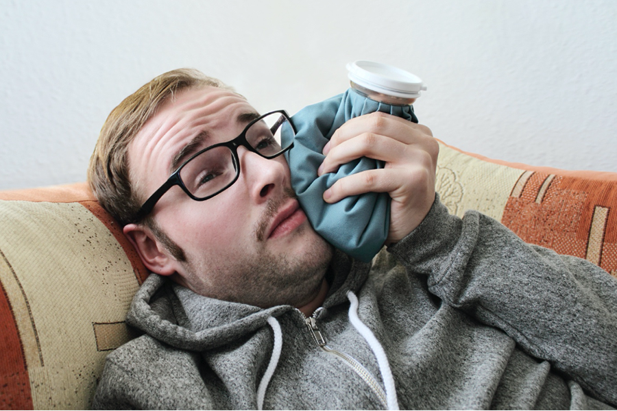 Man with ice pack on his jaw.