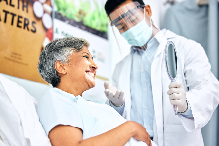 Dentist giving a dental checkup to an older adult