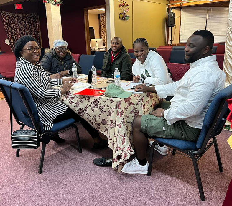 5 adults sharing a laugh at The River Arc