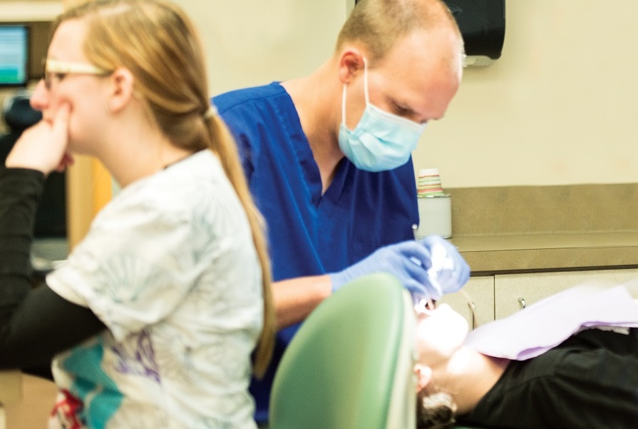Dentist working with patient