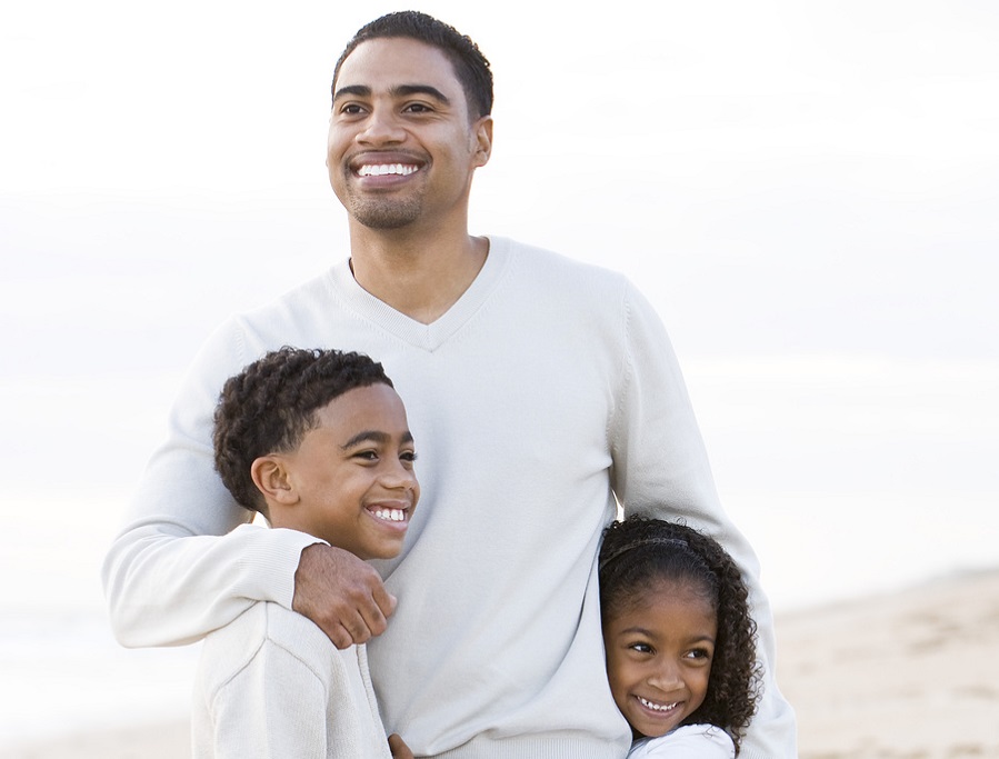 Dad hugging children