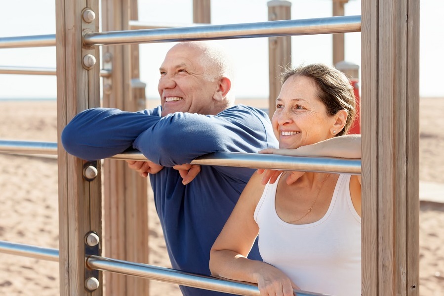 man and women hanging on fence
