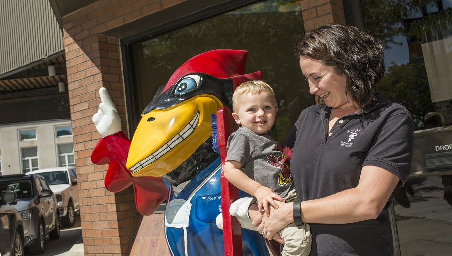 Mother and son standing next to the Iowa State mascot