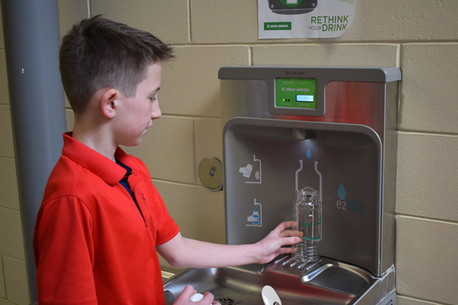 Boy filling waterbottle