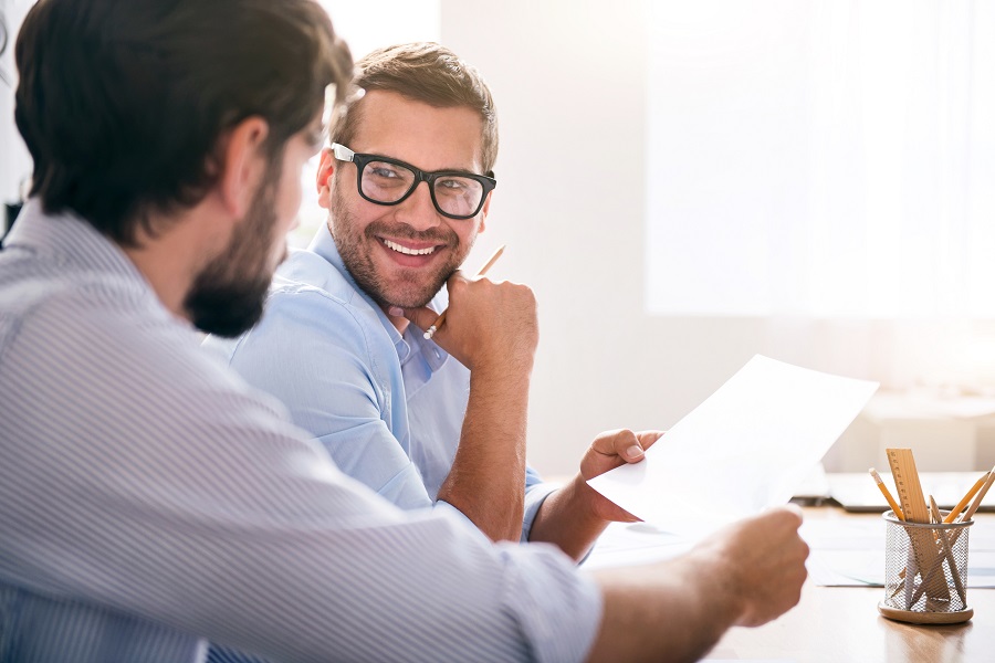 2 male businessmen communicating 