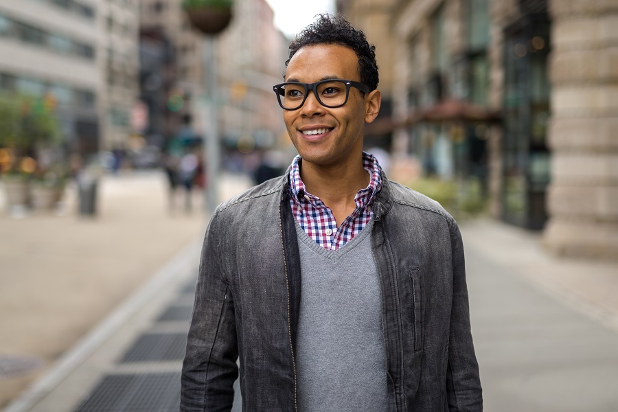 Man with glasses walking down the street