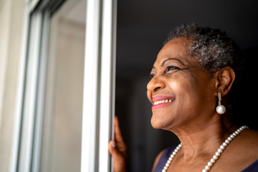 Older woman looking out window