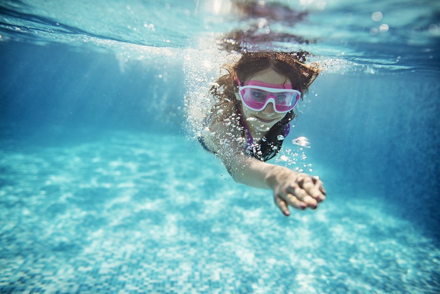 Girl swimming with goggles