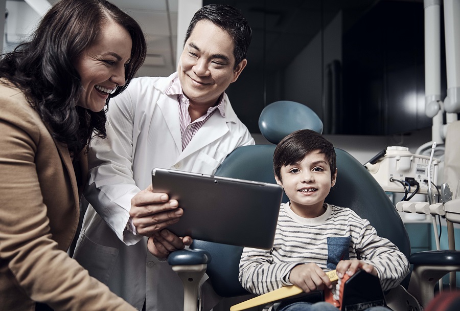 Dentist talking to a mother and son