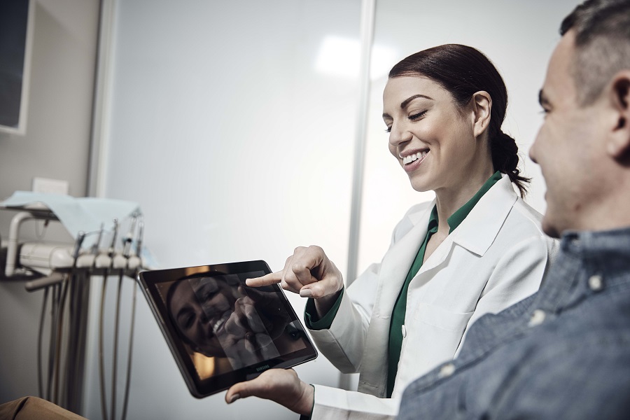 Dentist showing patient information