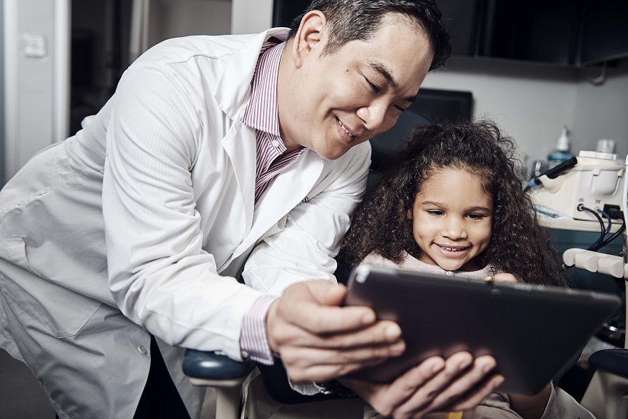 Dentist showing a little girl something