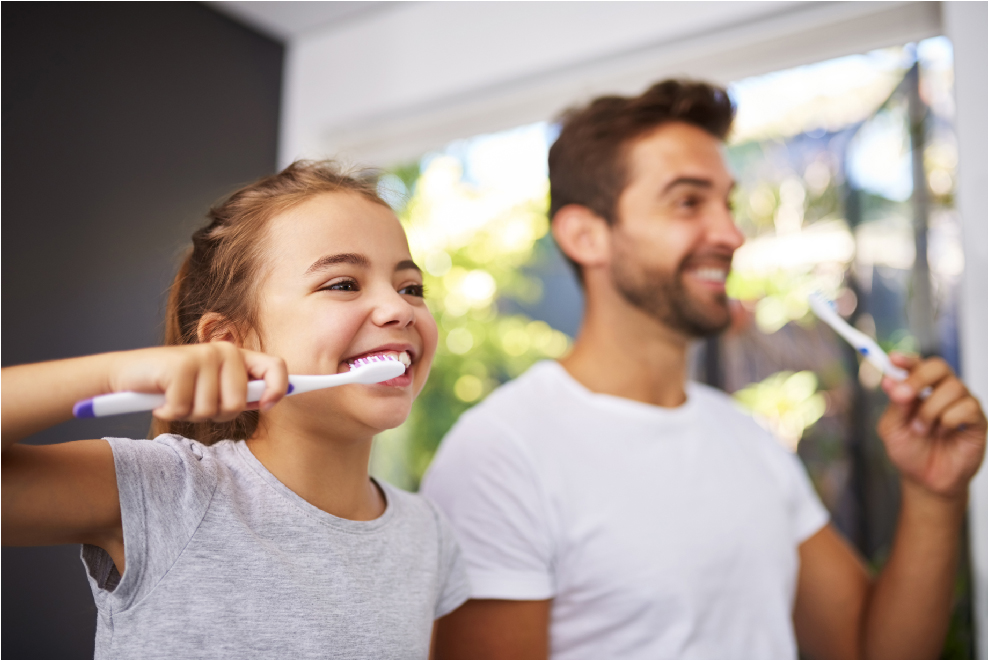 Little girl and dad brushing their teeth