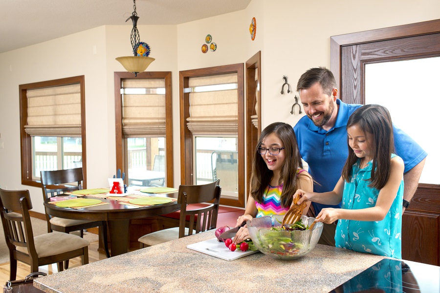 Dad and daughters making a salad