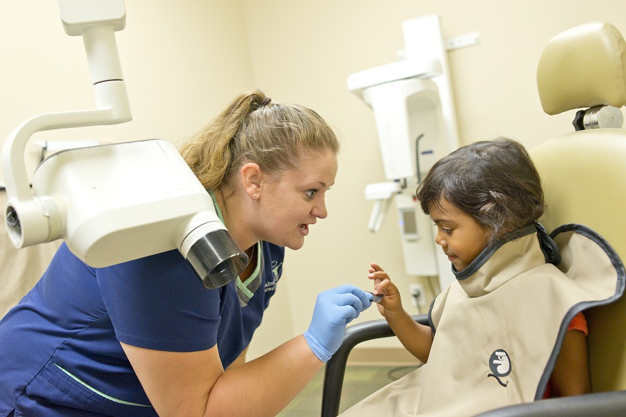 Dentist talking to child patient
