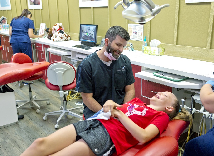 Dentist making kid patient laugh