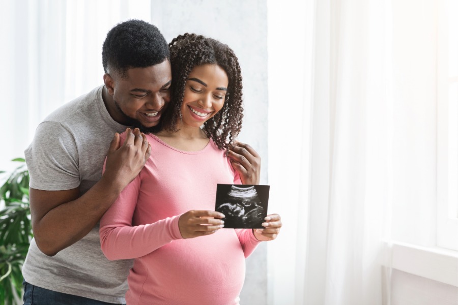 man and woman looking at an ultrasound picture