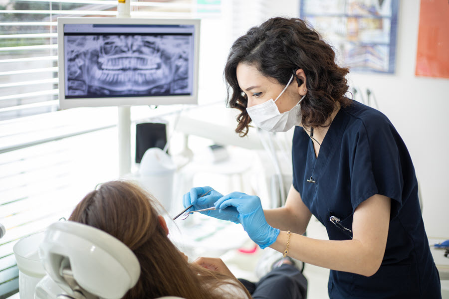 Woman dentist treating patient