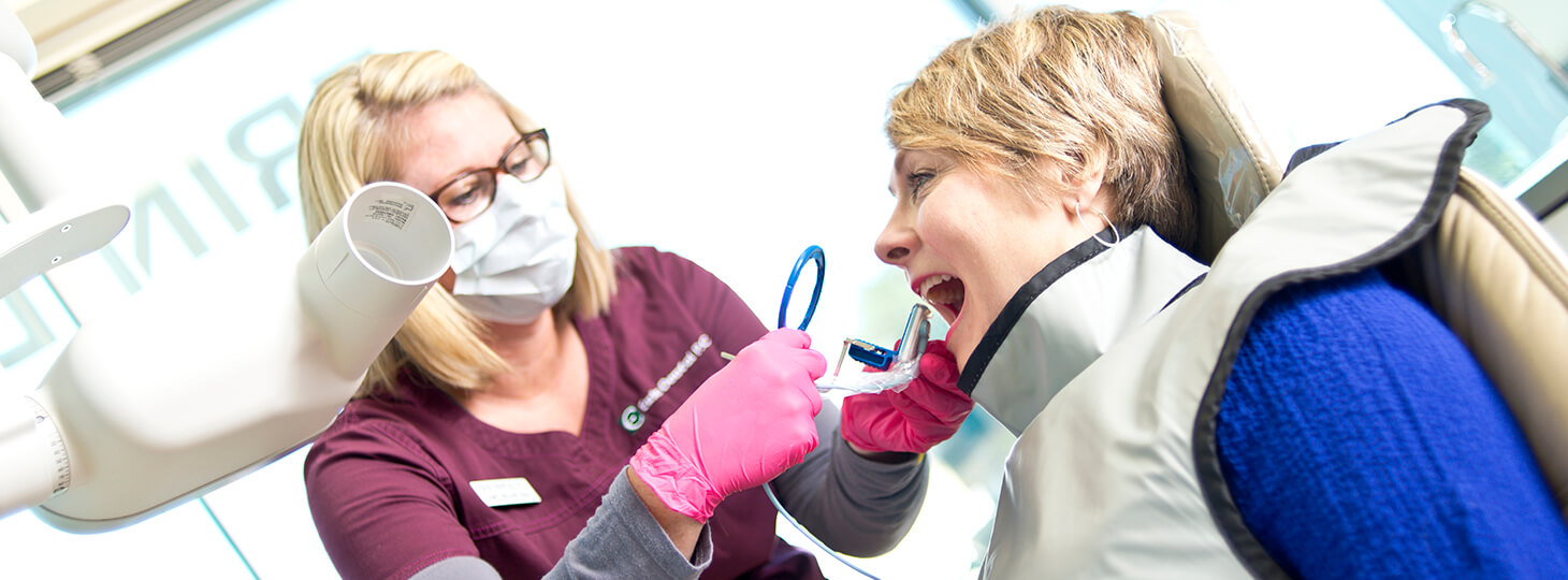 female patient getting her teeth cleaned