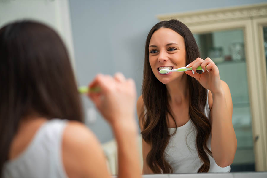 woman brushing her teeth