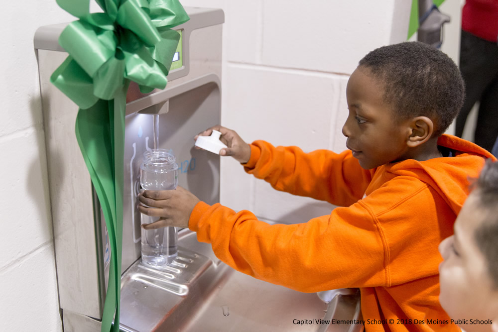 Student using water bottle filling station provided by Delta Dental of Iowa