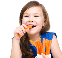 little girl eating carrots