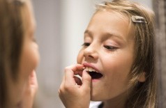 little girl pulling a tooth