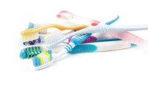 Toothbrushes piled on white background