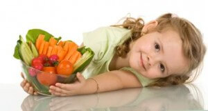 Little girl with a bowl of vegetables