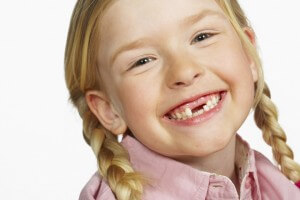 girl missing teeth smaller